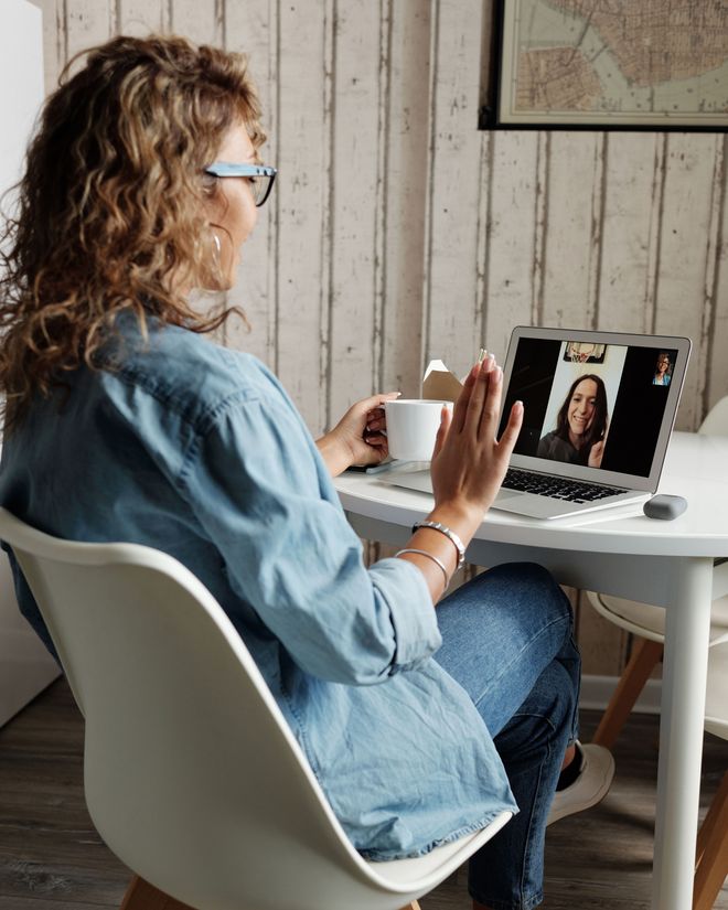 A coach on a video call with two other coaches on screen